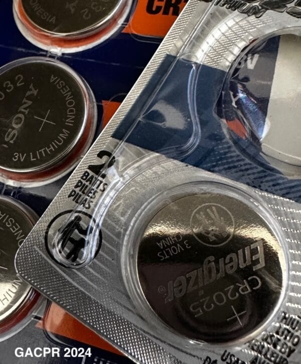 Image showing button, or coin cell batteries in packages.